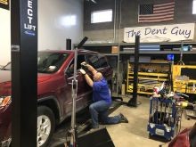 The Dent Guy performing dent removal with paintless dent repair and glue pull repair