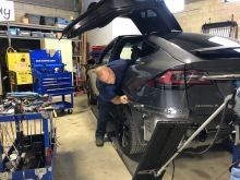 The Dent Guy working on a Tesla Model X.